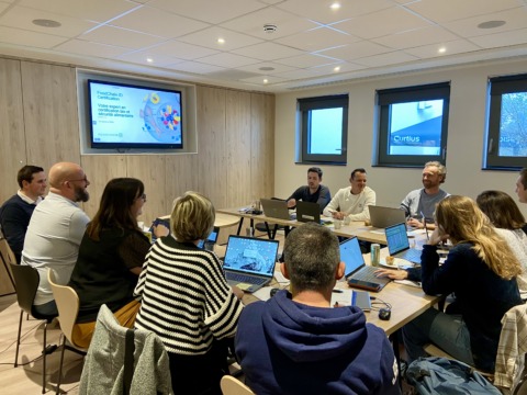 Groep collega's in vergadering in de vergaderzaal tijdens een residentieel seminarie bij Radisson Liège City Centre